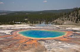 The Grand Prismatic Spring, viewed from above. There is a trail that goes around the back of the spring which has a small turn-off that lets intrepid climbers rise about 400 feet above the spring, and capture the entire basin in one view.  For a closer view, there are raised boardwalks around the spring and nearby pools (viewable in the detail of the picture)