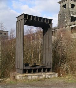 Section of the original wrought-iron tubular Britannia Bridge standing in front of the modern bridge