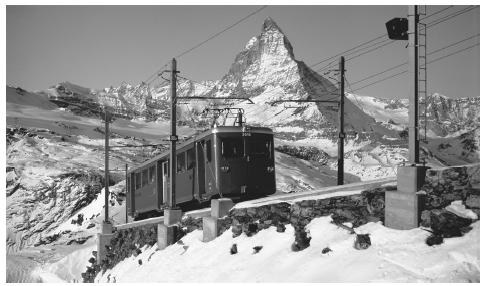 The Matterhorn towers beyond a railway as it ascends toward Gornergrat. Skiing and tourism are an important part of the Swiss economy.